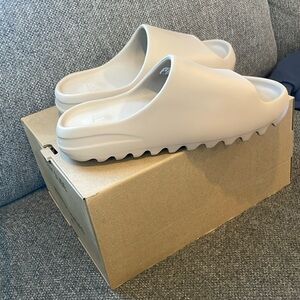 Yeezy slides size Men’s 9, color Pure. Brand new, in box, never worn